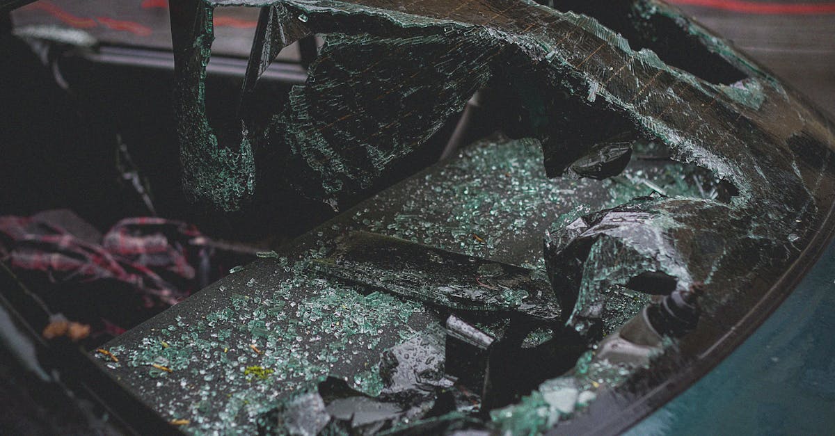 detailed view of shattered car windshield after accident emphasizing damage and broken glass